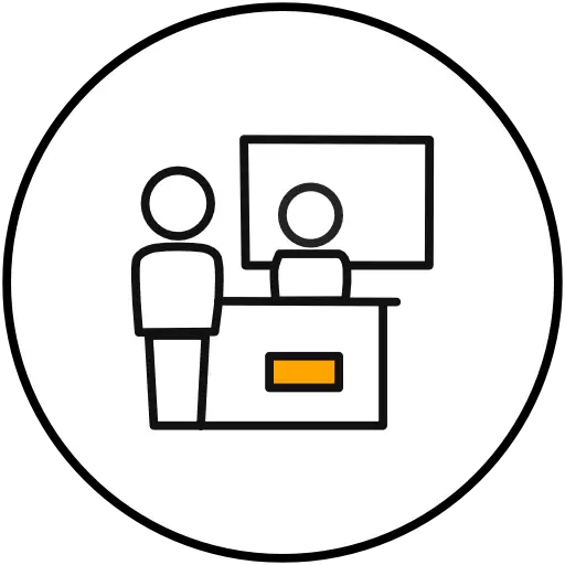 Two people at a counter with a monitor, representing event video production in Frankfurt